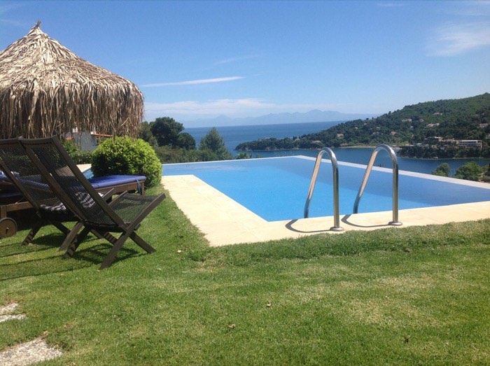 The pool and terrace of Villa Bougainvillea looking out to the sea